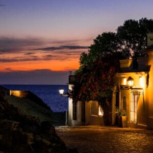 Explore the charming colonial architecture at sunset in Colonia del Sacramento, Uruguay. Ideal for travel enthusiasts.